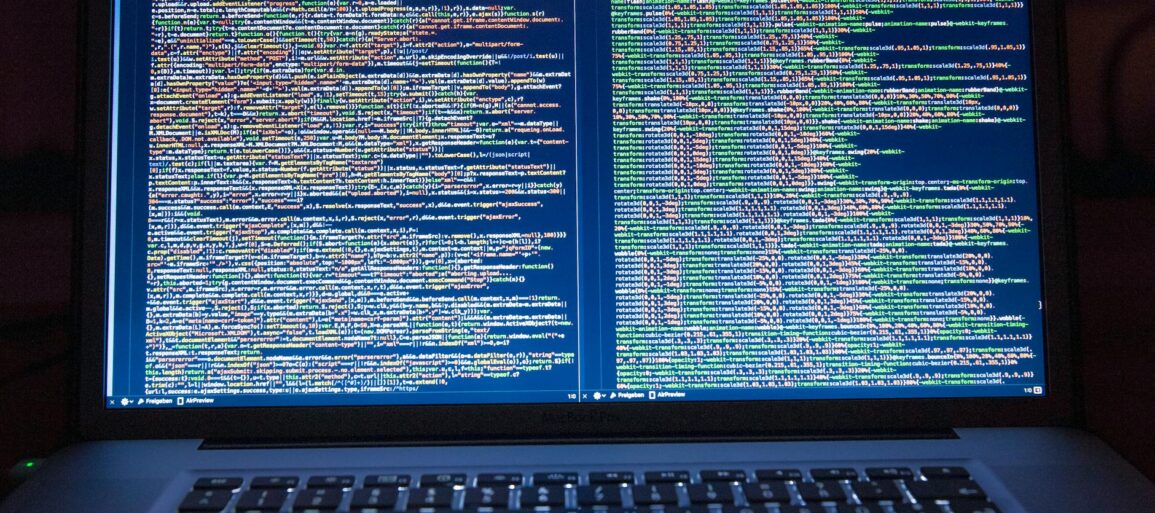black laptop computer turned on showing computer codes